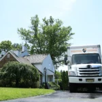 Pick and Pack Moving truck parked in front of a suburban home, ready for out-of-state relocation