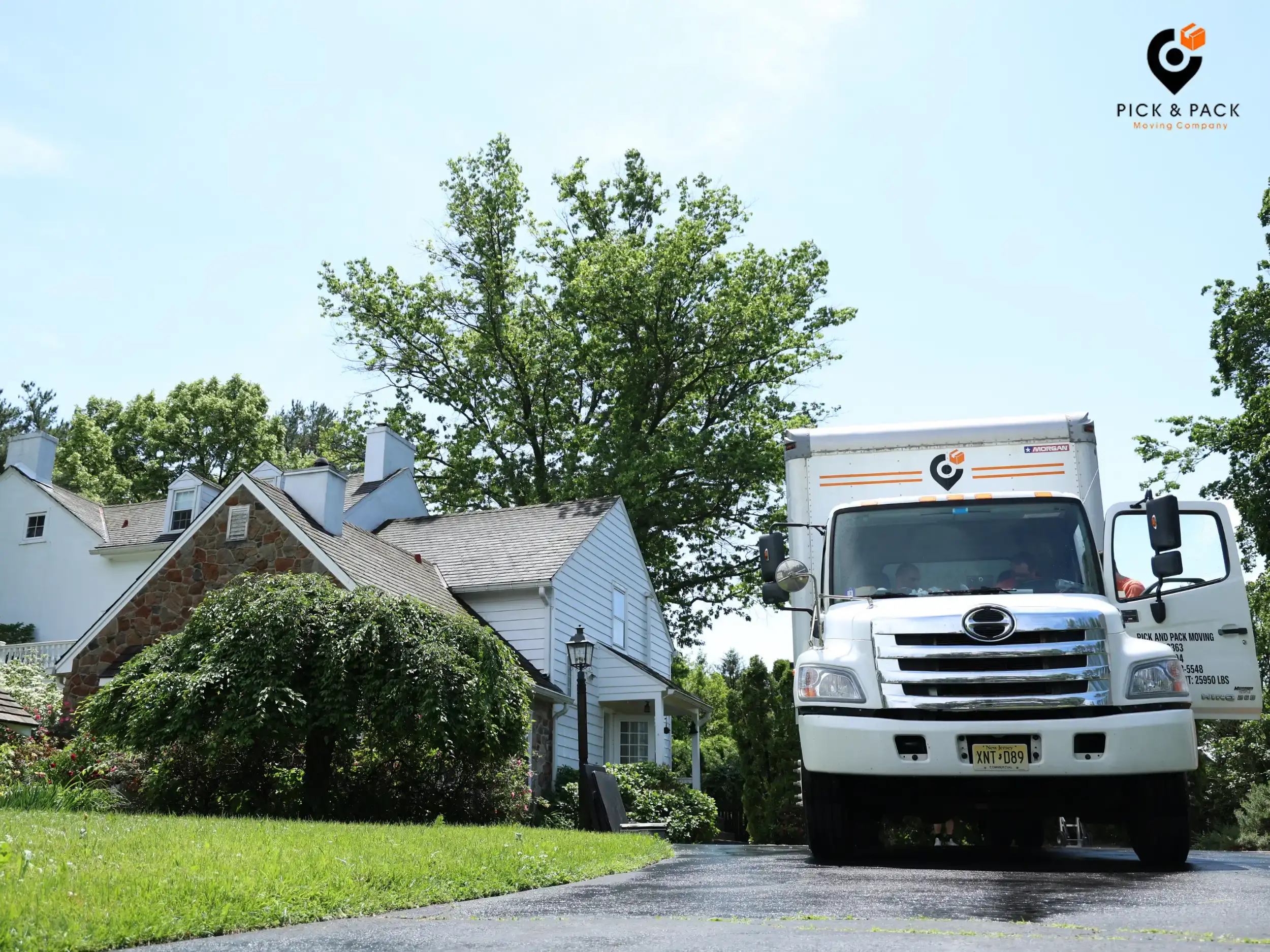 Pick and Pack Moving truck parked in front of a suburban home, ready for out-of-state relocation