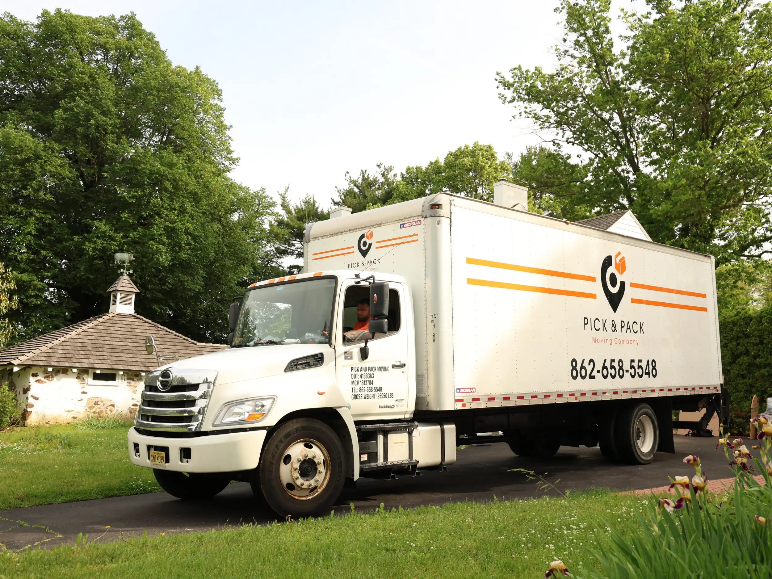 Pick and Pack long-distance moving truck driving through a suburban area, ready for interstate relocation