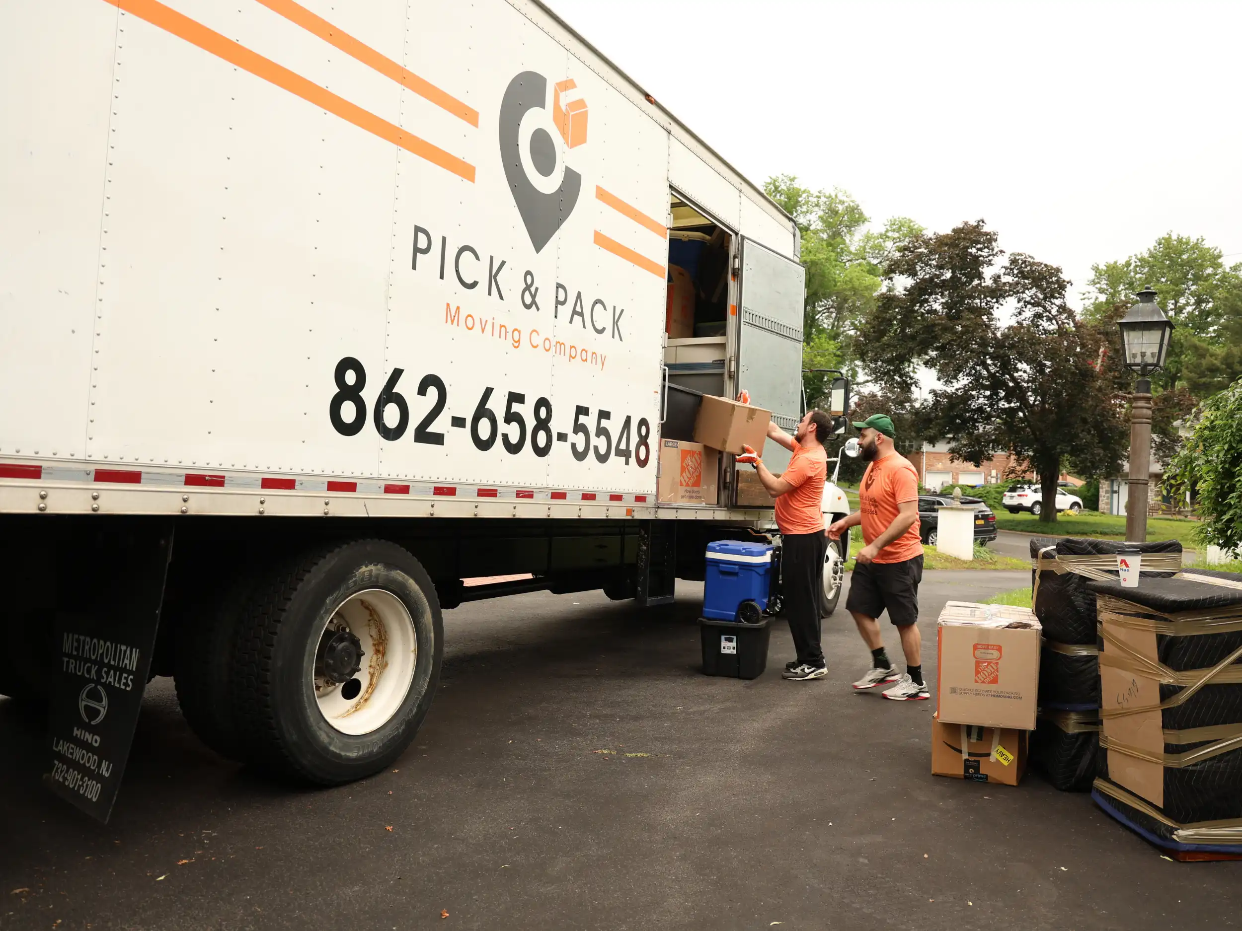Professional NJ movers loading labeled boxes into Pick and Pack Moving truck