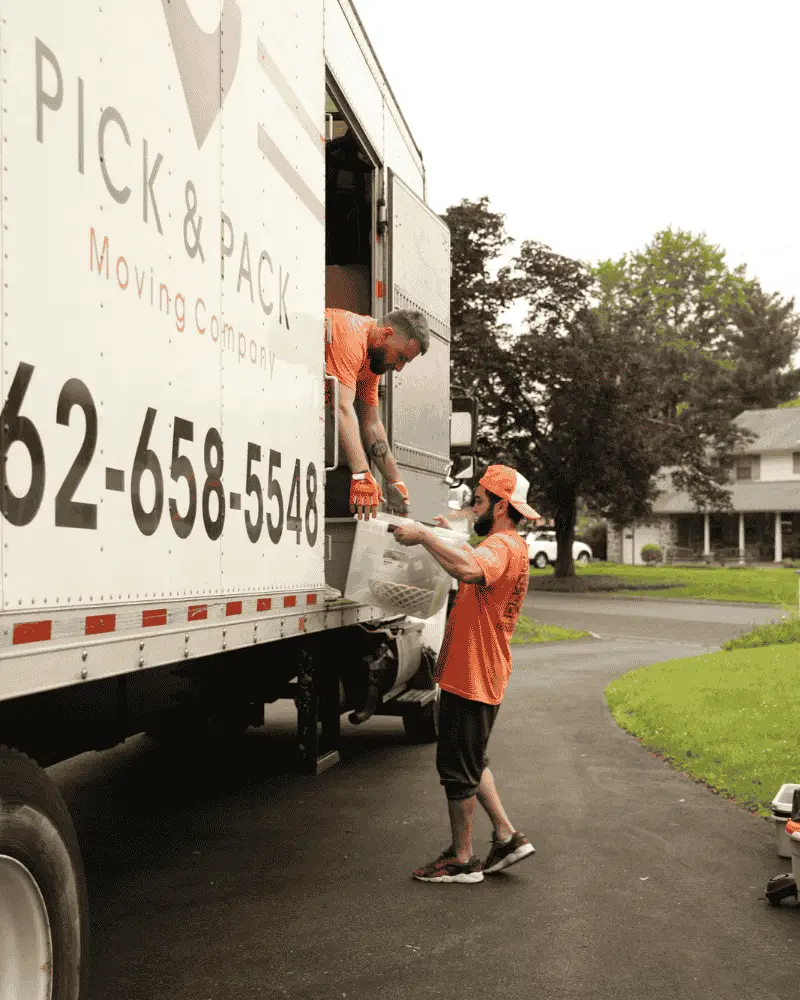 Professional movers loading boxes into Pick and Pack Moving truck