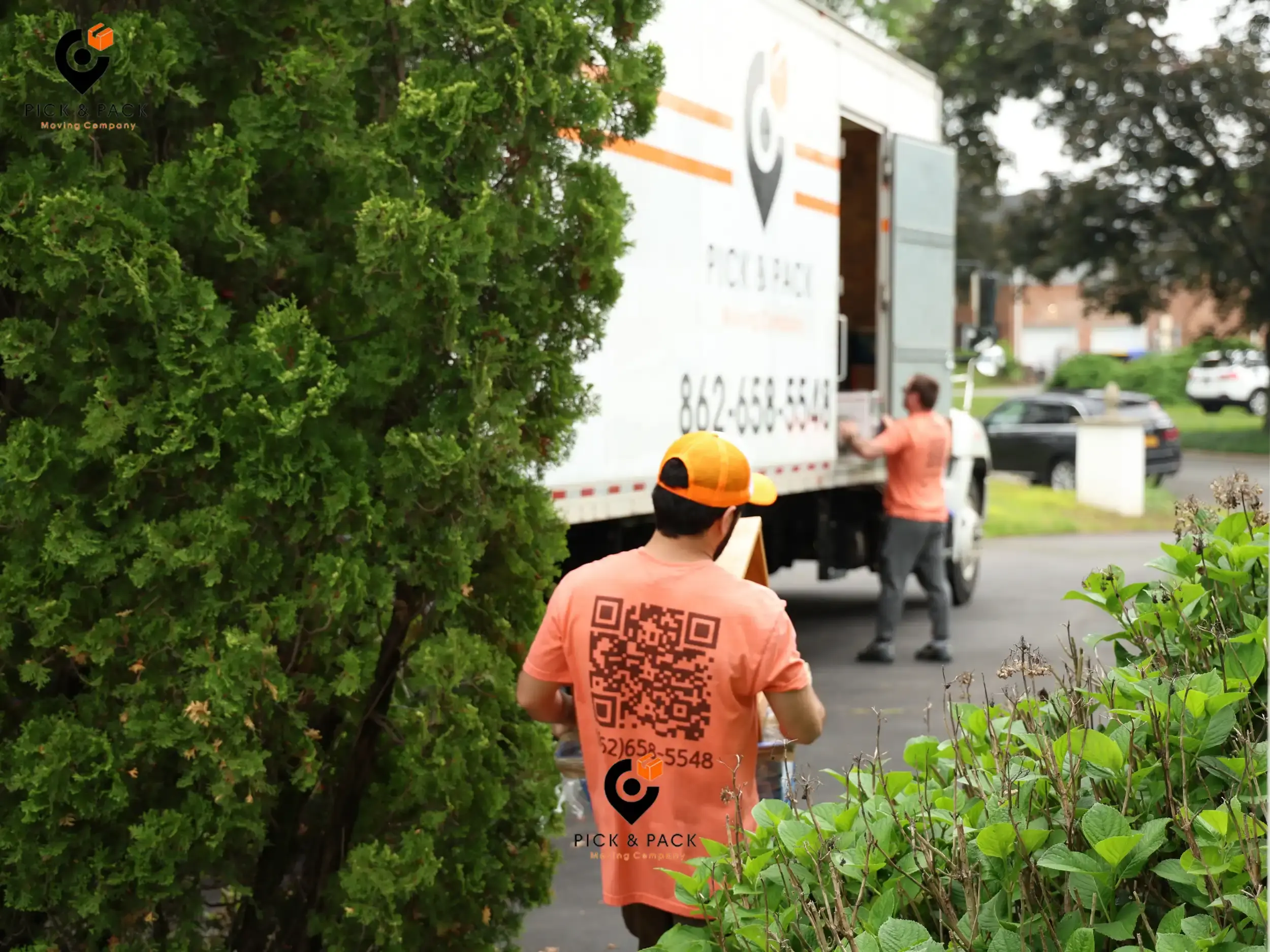 Professional movers loading items into a truck during a long-distance move