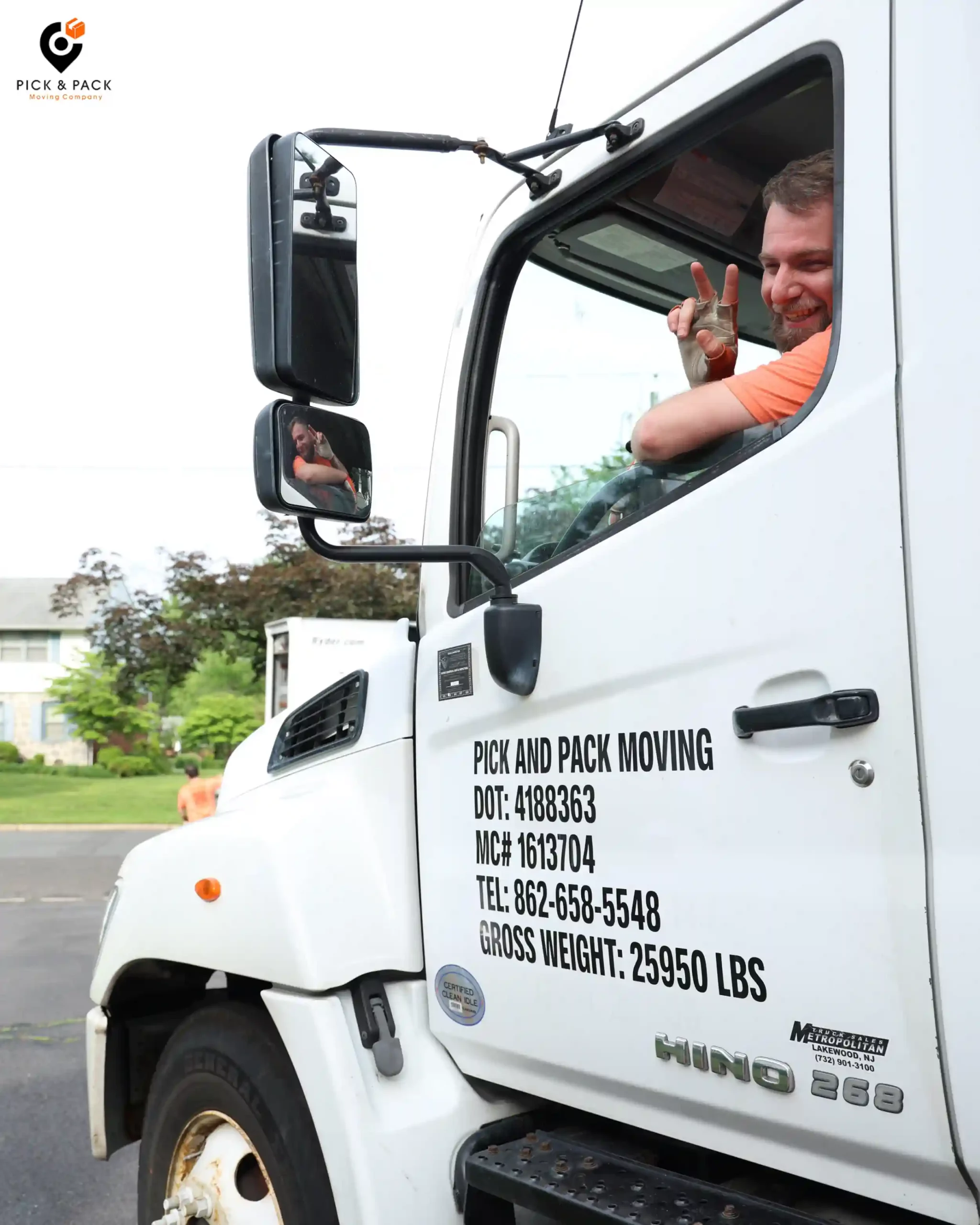 Moving truck driver giving peace sign during long-distance move for Pick and Pack Moving