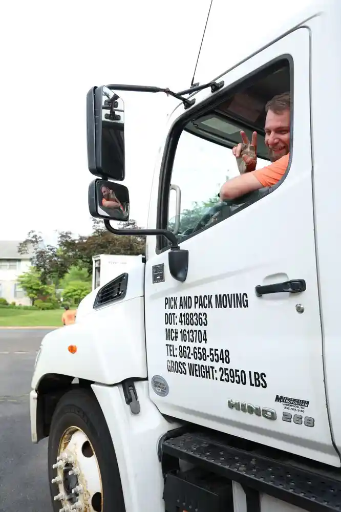 Licensed Pick and Pack mover waving from the cab of a Princeton, NJ moving truck