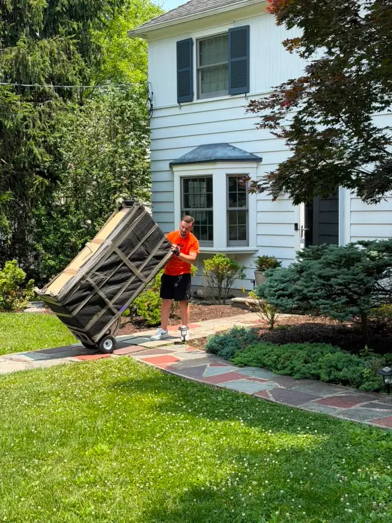 Pick and Pack mover using a dolly to move furniture into an Ocean County home