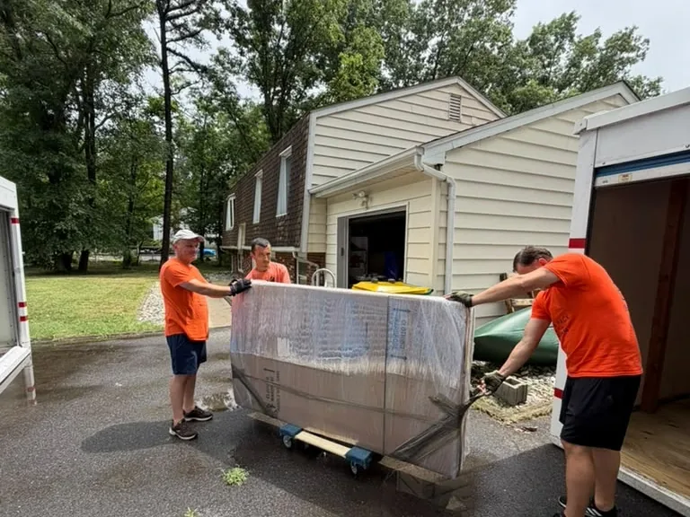 Hamilton movers carefully moving a large, heavy item