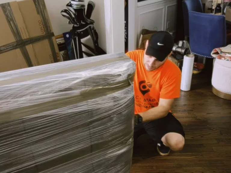 Hamilton movers wrapping furniture before loading