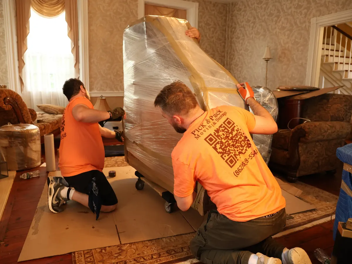 Pick and Pack crew wrapping a piano for a Ridgewood move