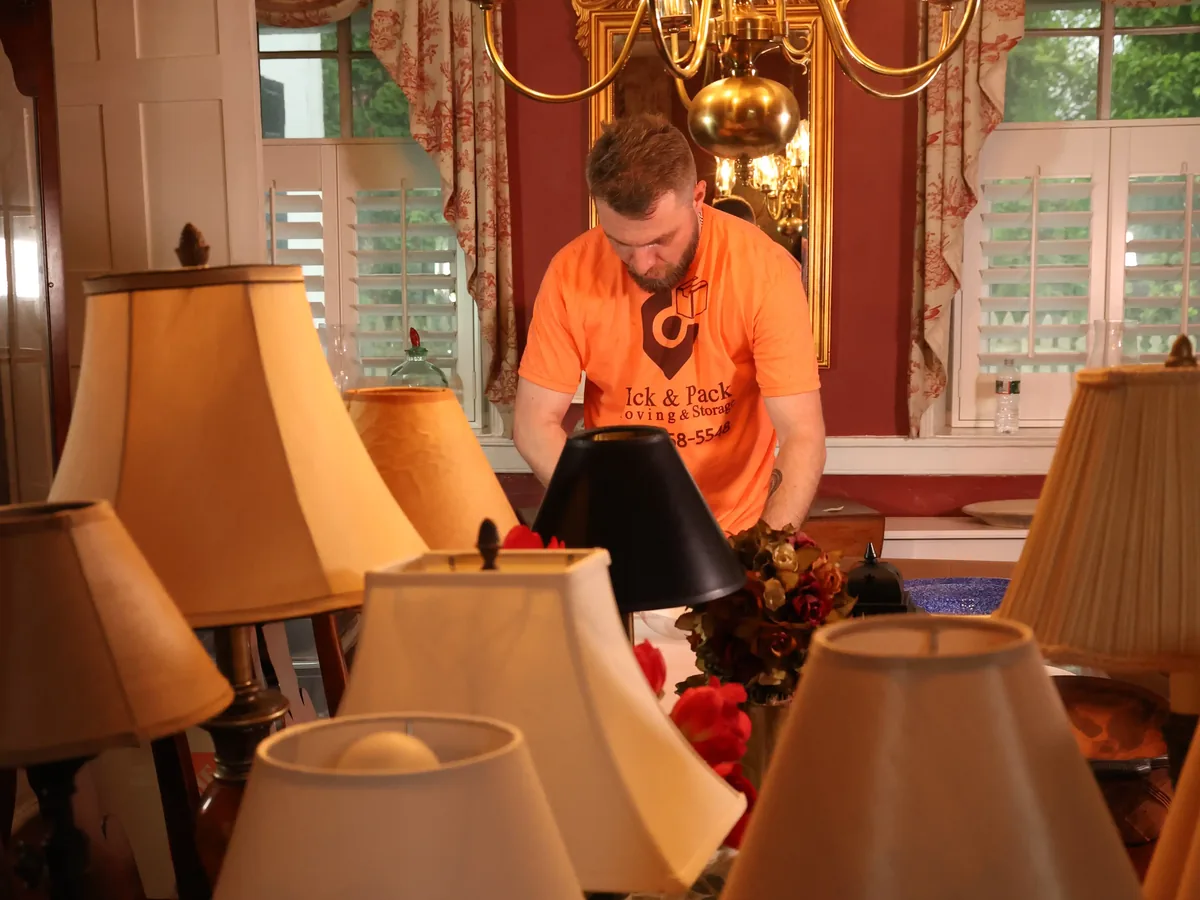 Ridgewood movers wrapping antique furniture in a historic home